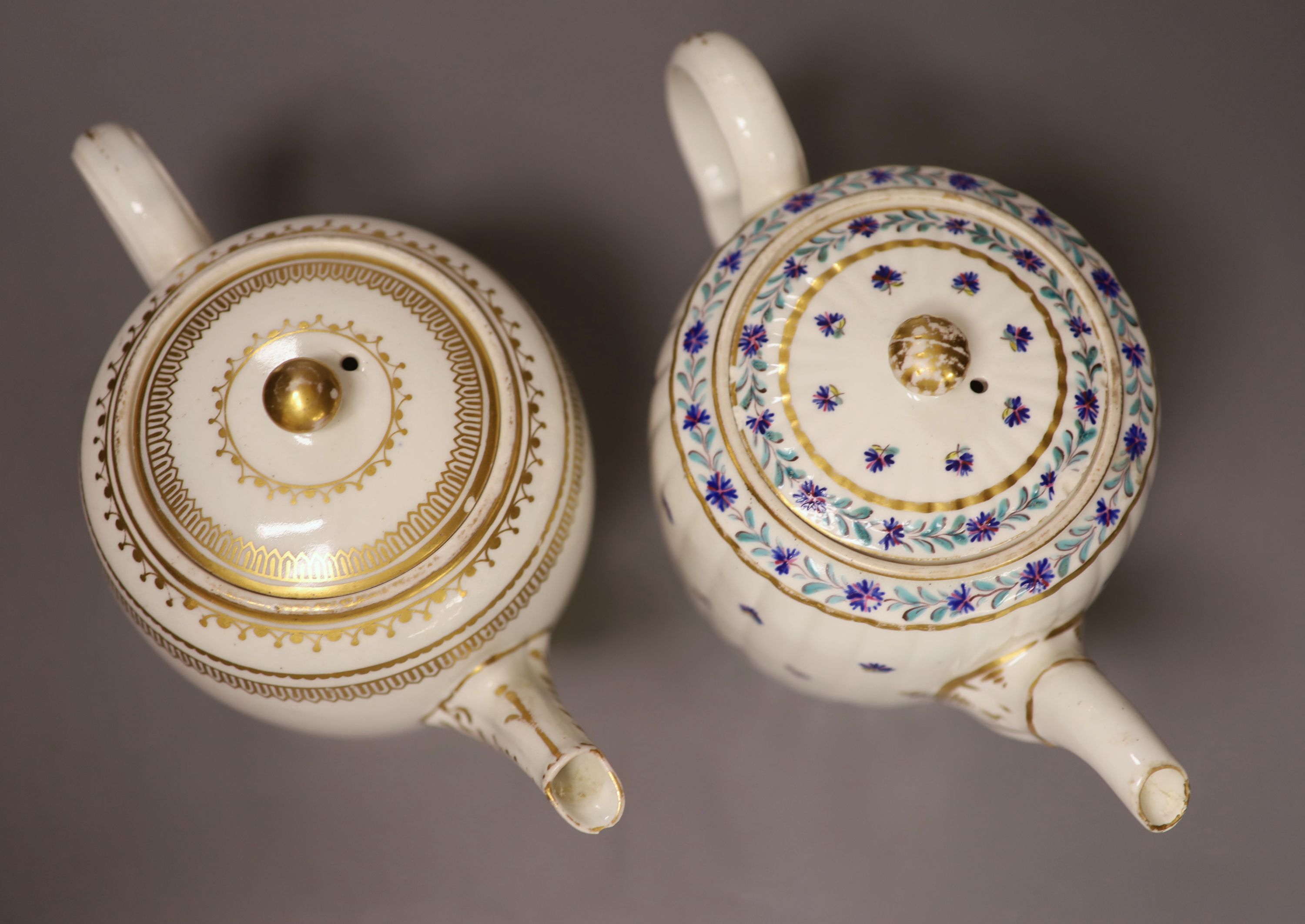 A Caughley teapot and cover, painted with cornflowers and another Caughley teapot and cover with gilded decoration